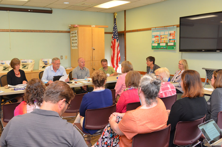 County officials meet with residents to discuss library programs and performance.